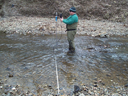 Person collecting sample at Hinkson Creek
